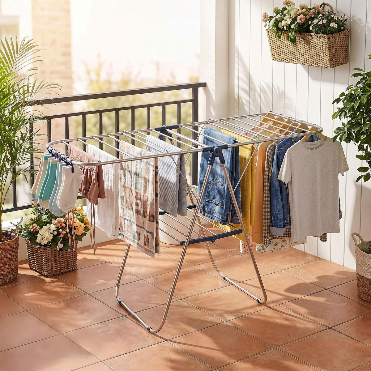 An open metal drying rack holds assorted laundry on a tiled patio.