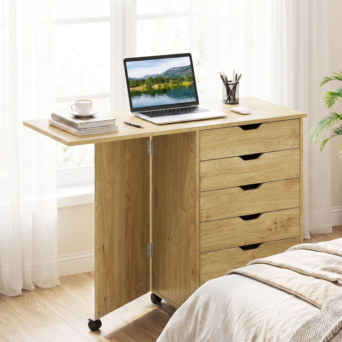 Natural-finish folding desk open as a workspace in a bright bedroom