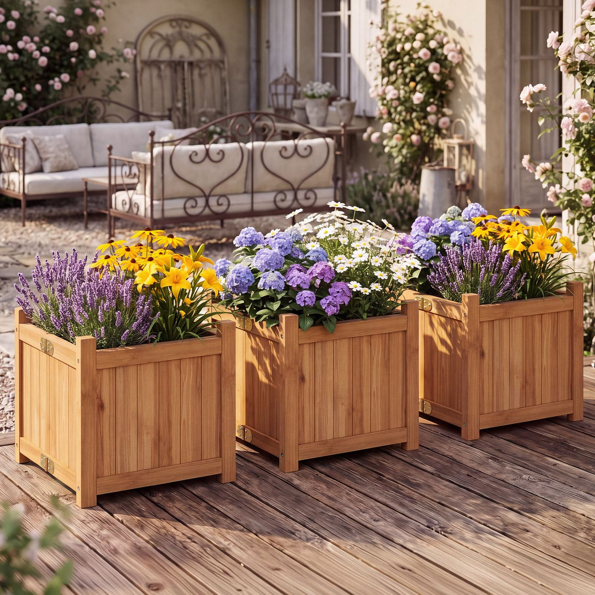 Three warm wood raised garden beds filled with flowers on a patio