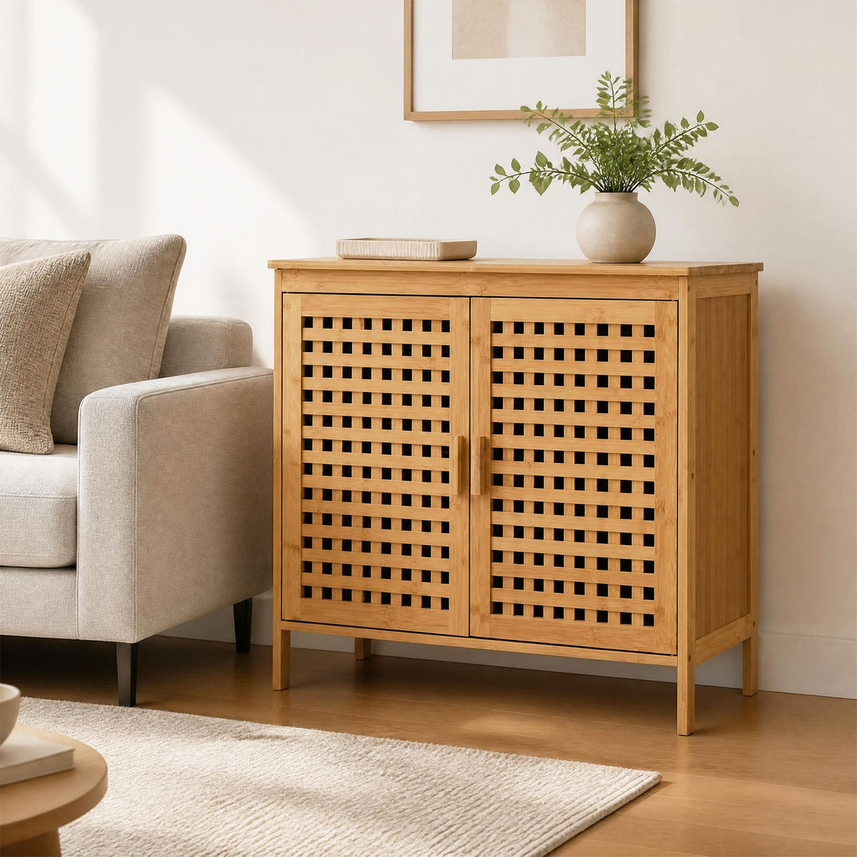 Closed bamboo cabinet styled beside a sofa, with a plant and small tray on top.
