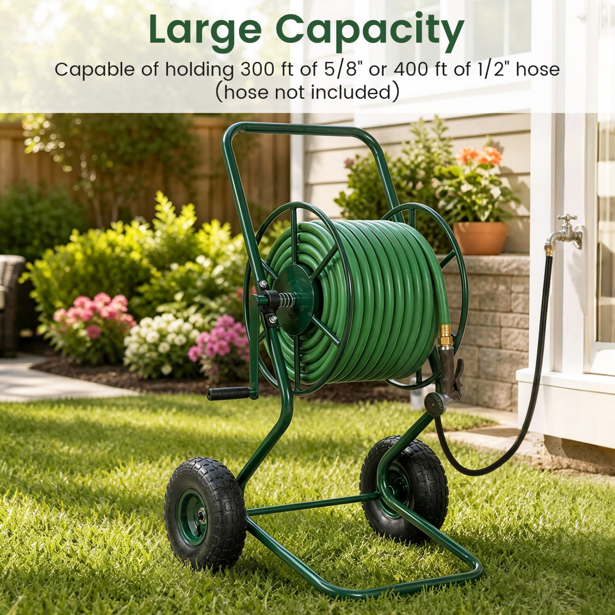Green hose reel cart loaded with a green hose stands on a lawn beside a garden path.