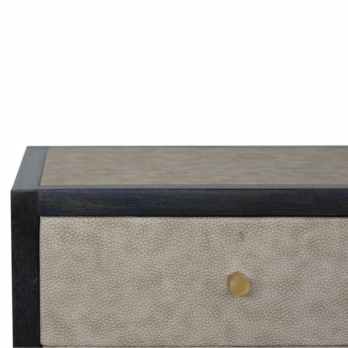 Close-up of the nightstand top edge and upper drawer with a gold-tone knob