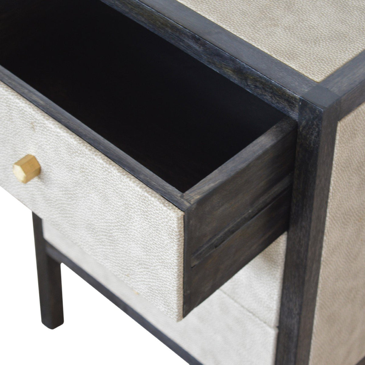 Nightstand drawer pulled open, showing its dark interior and faux leather front