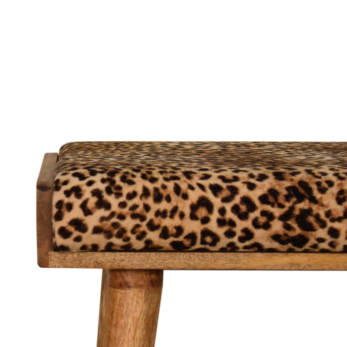 Close-up side view of the leopard-print upholstered top and warm-toned wood frame