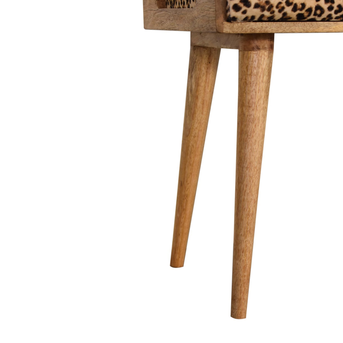 Detail view of the wood frame and tapered legs beneath the leopard-print upholstered seat