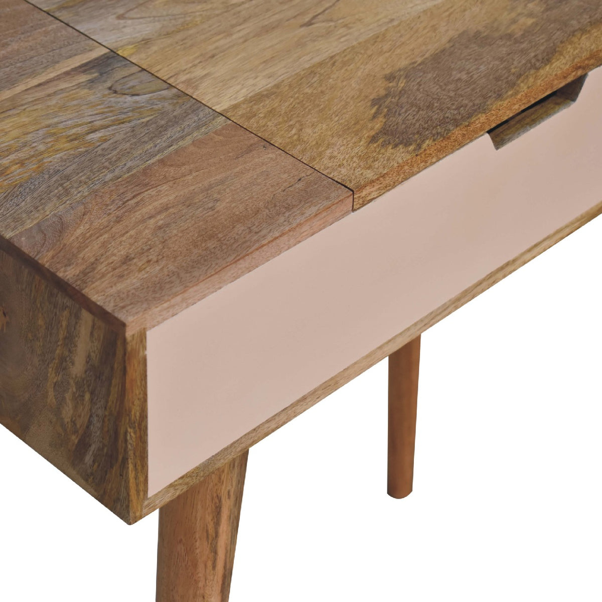 Close-up of the oak-tone tabletop, blush drawer front and cutout slot