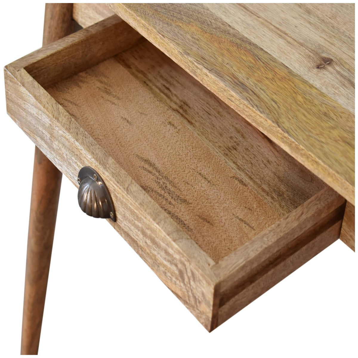 Close-up of the open wooden desk drawer and its brass shell handle