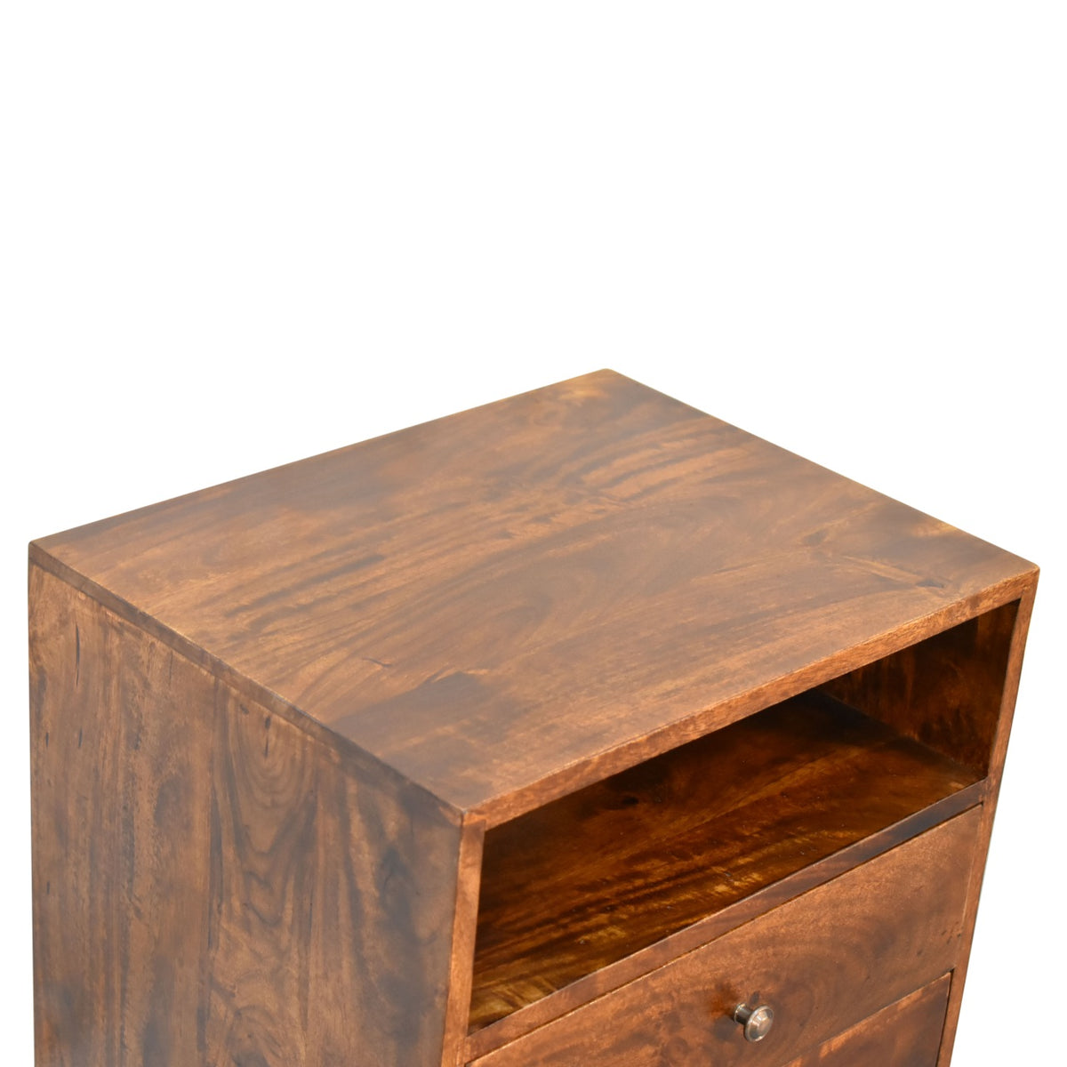 Angled overhead view of the nightstand's wood top, open shelf, and upper drawer