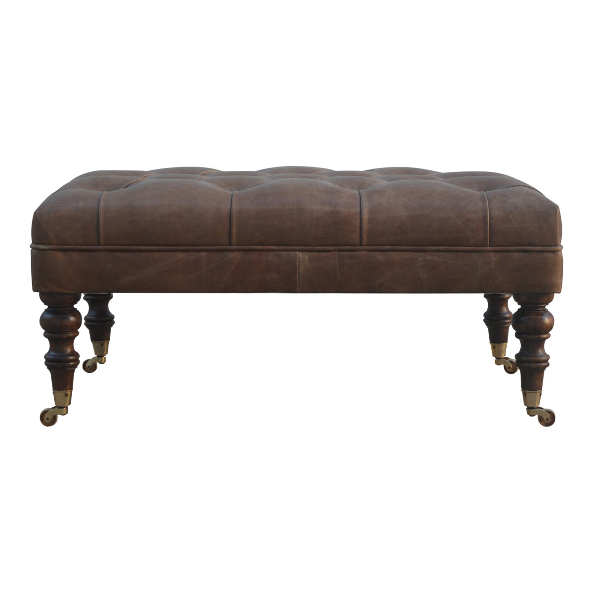 Brown leather ottoman in straight-on front view with buttoned top and turned legs.
