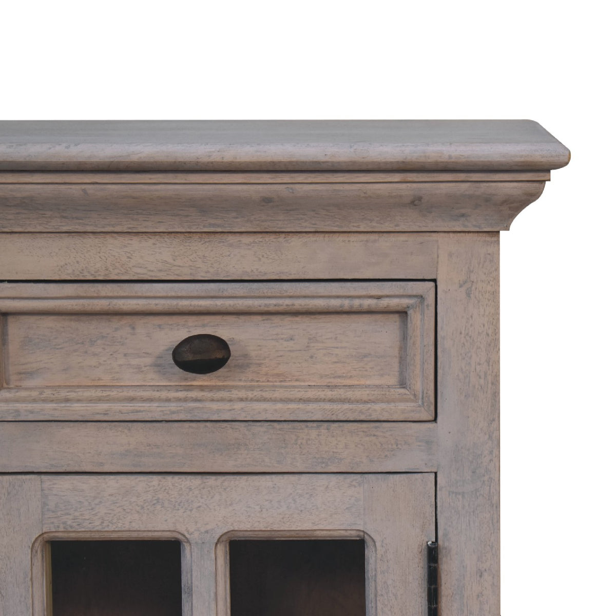 Close view of the pale gray nightstand's top drawer and glazed cupboard door