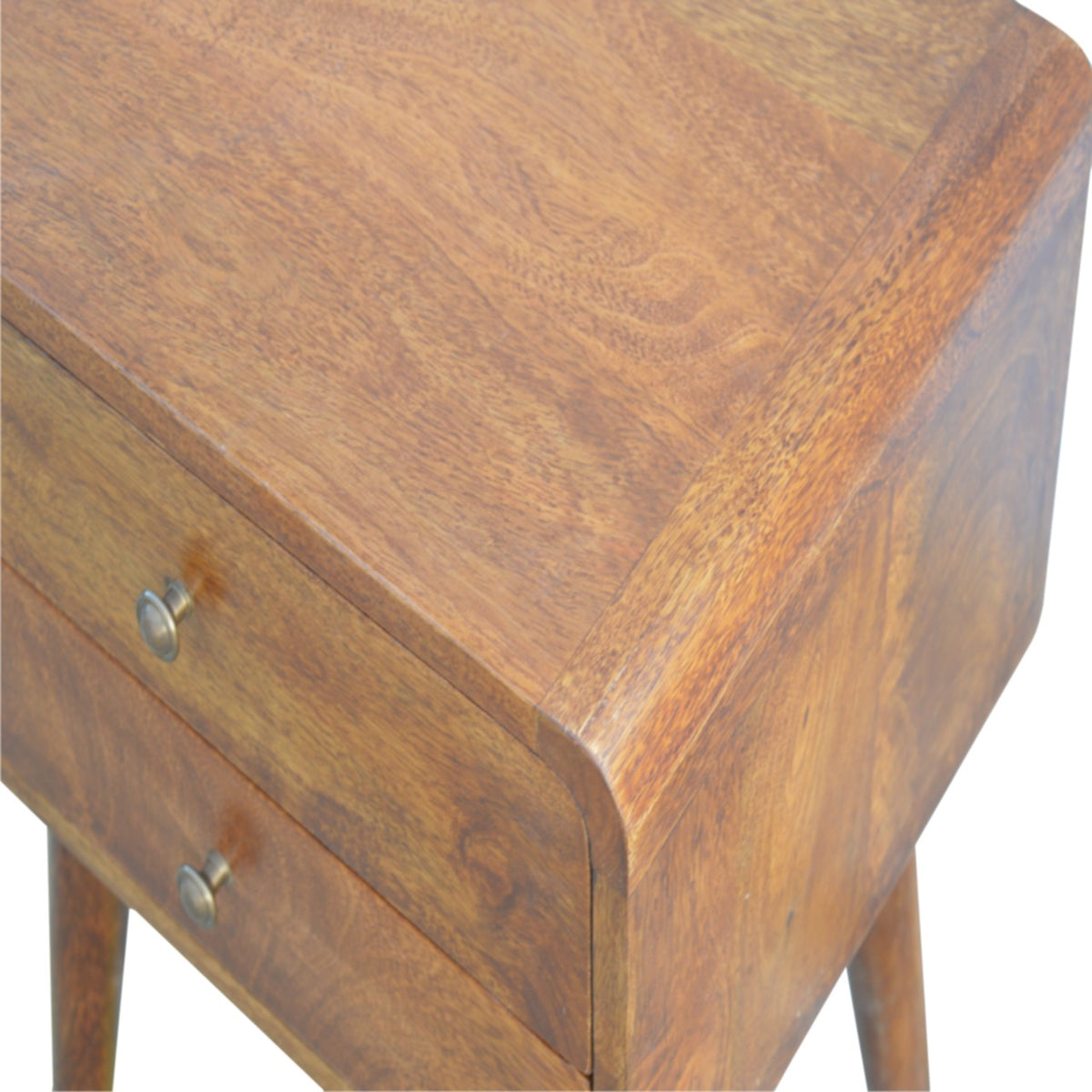 Close-up of the chestnut wood nightstand's rounded top corner and drawer knobs