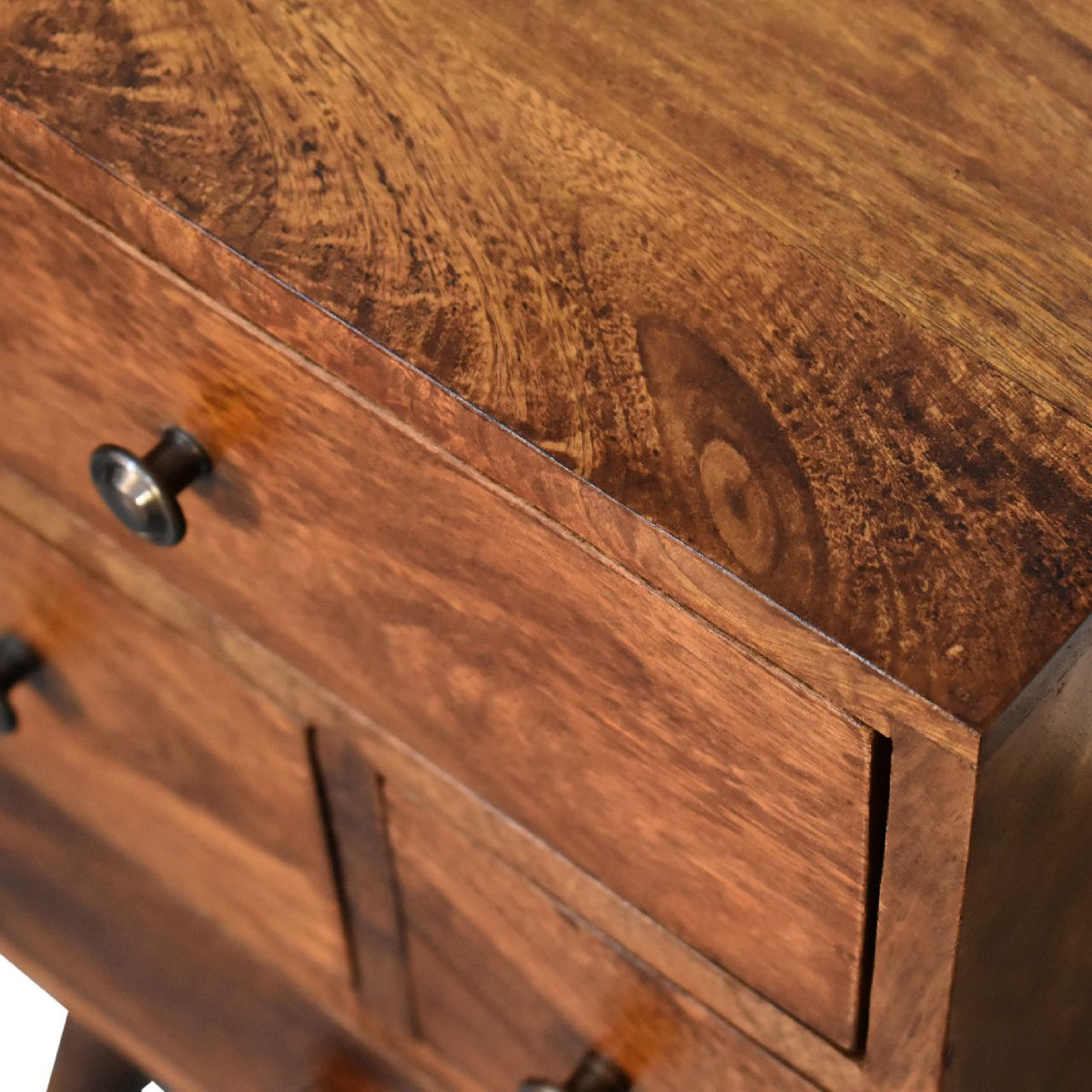 Angled close-up of the chestnut nightstand's wood top and drawer fronts