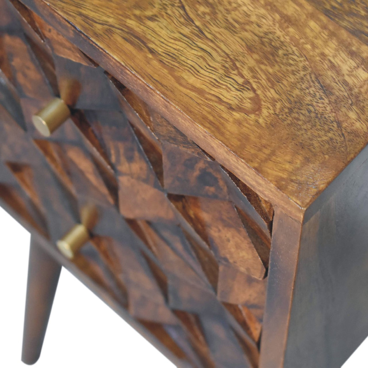 Close-up of the chestnut wood grain, cube-carved drawer fronts, and round drawer pulls