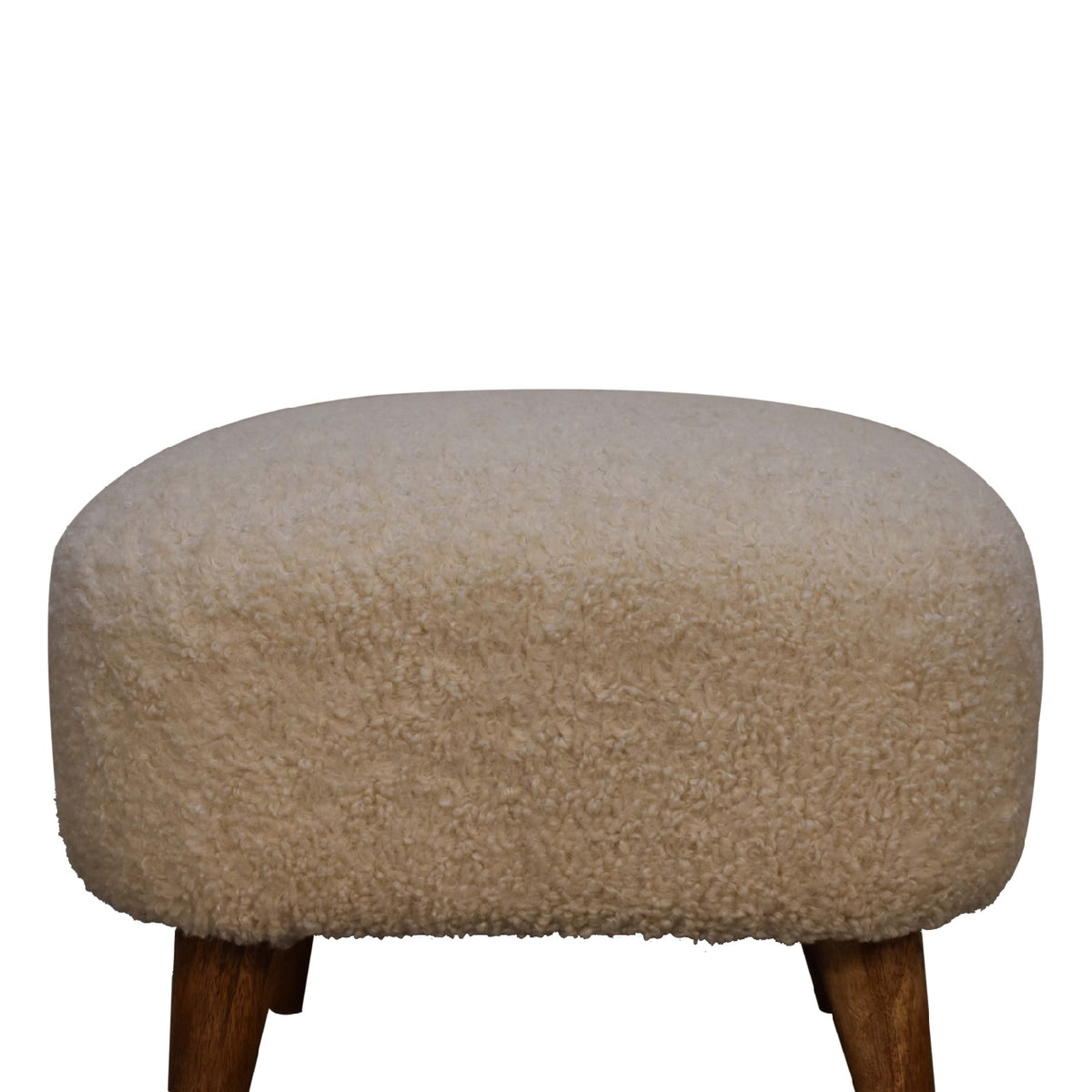 Close front view of the cream boucle upholstery and wood legs against white