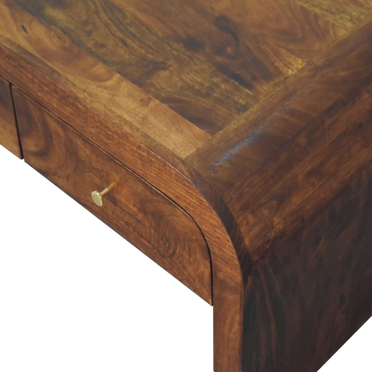Close-up of the brown tabletop corner, curved edge and drawer front