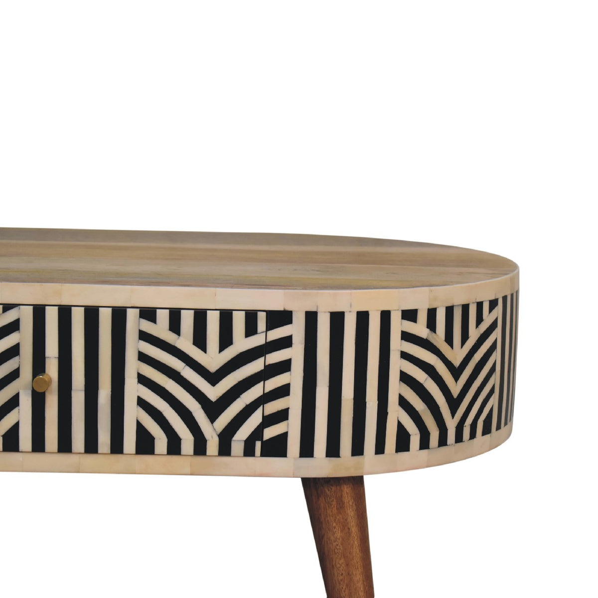 Close view of the black and cream geometric inlay along the table front