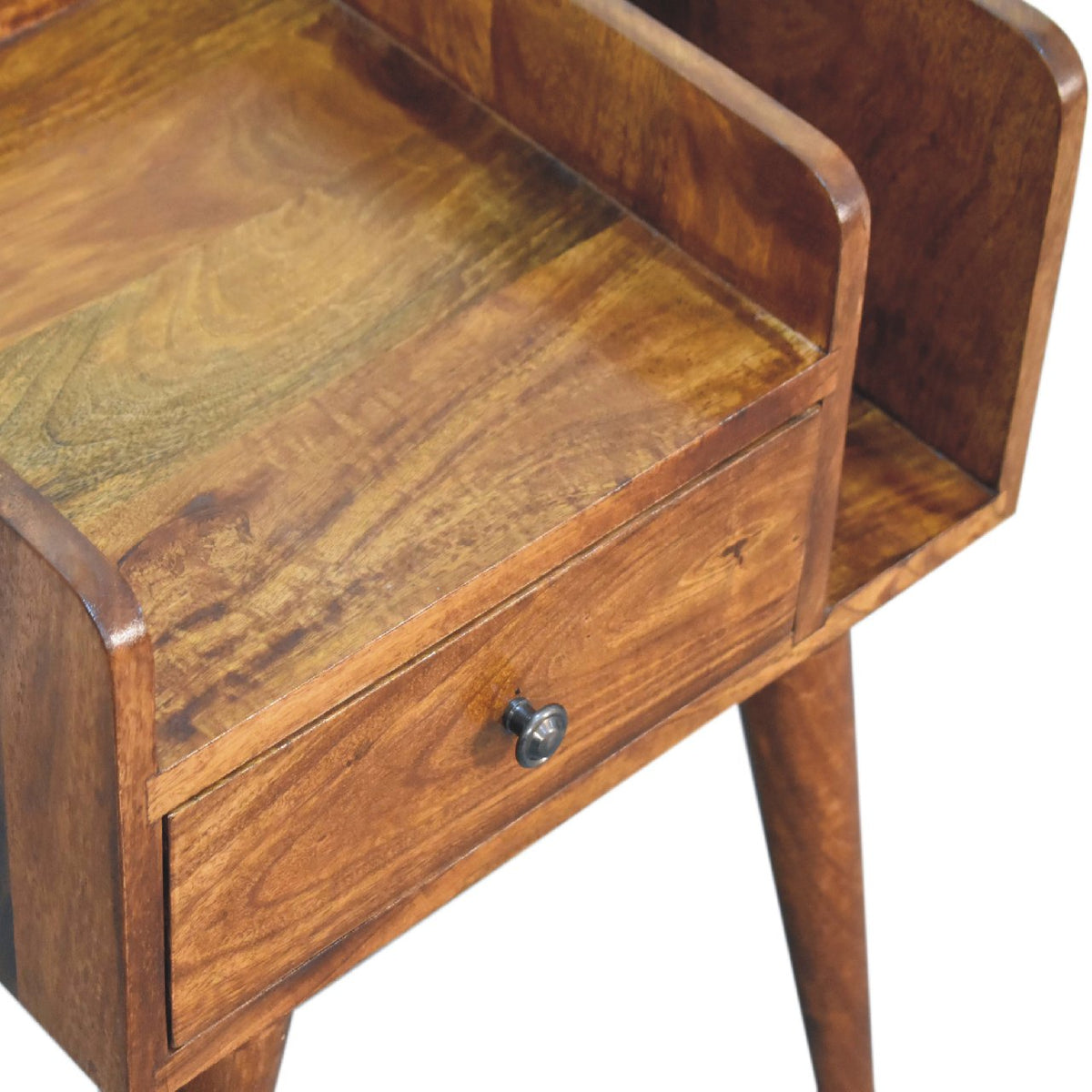 Angled close-up of the brown nightstand top, open slot and drawer knob