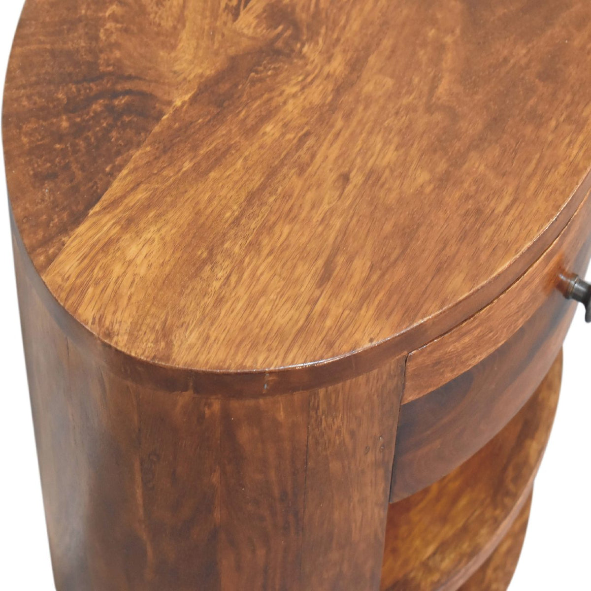 Top-down close-up showing the rounded chestnut-brown tabletop and wood grain