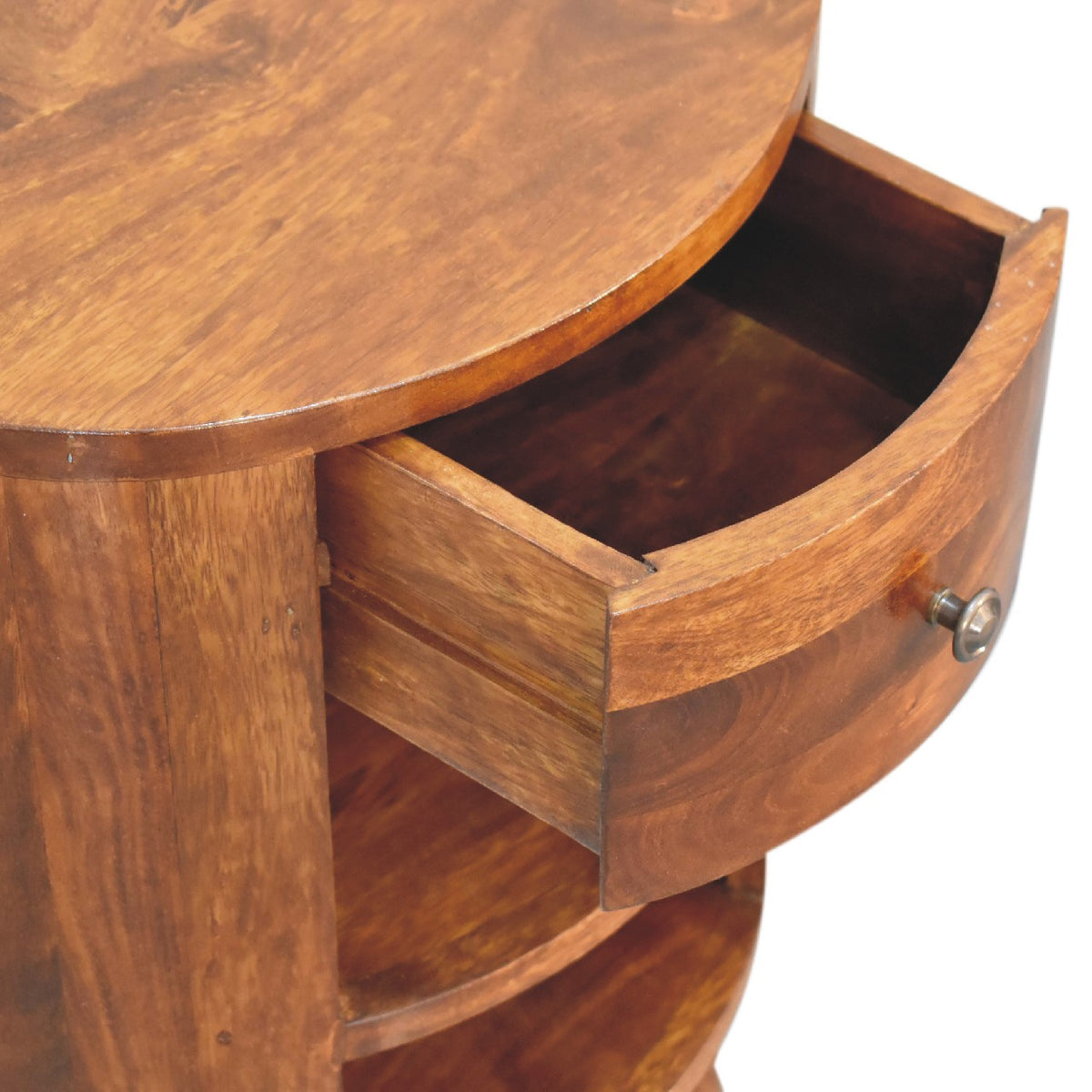 Close-up of the nightstand with its drawer open above the open shelves