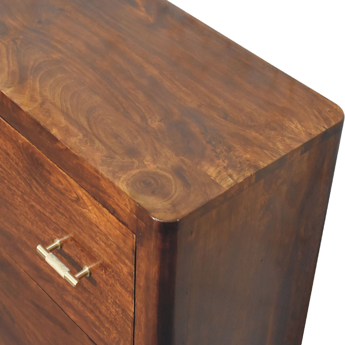 Close-up angled view of the chestnut wood top, rounded corner and side