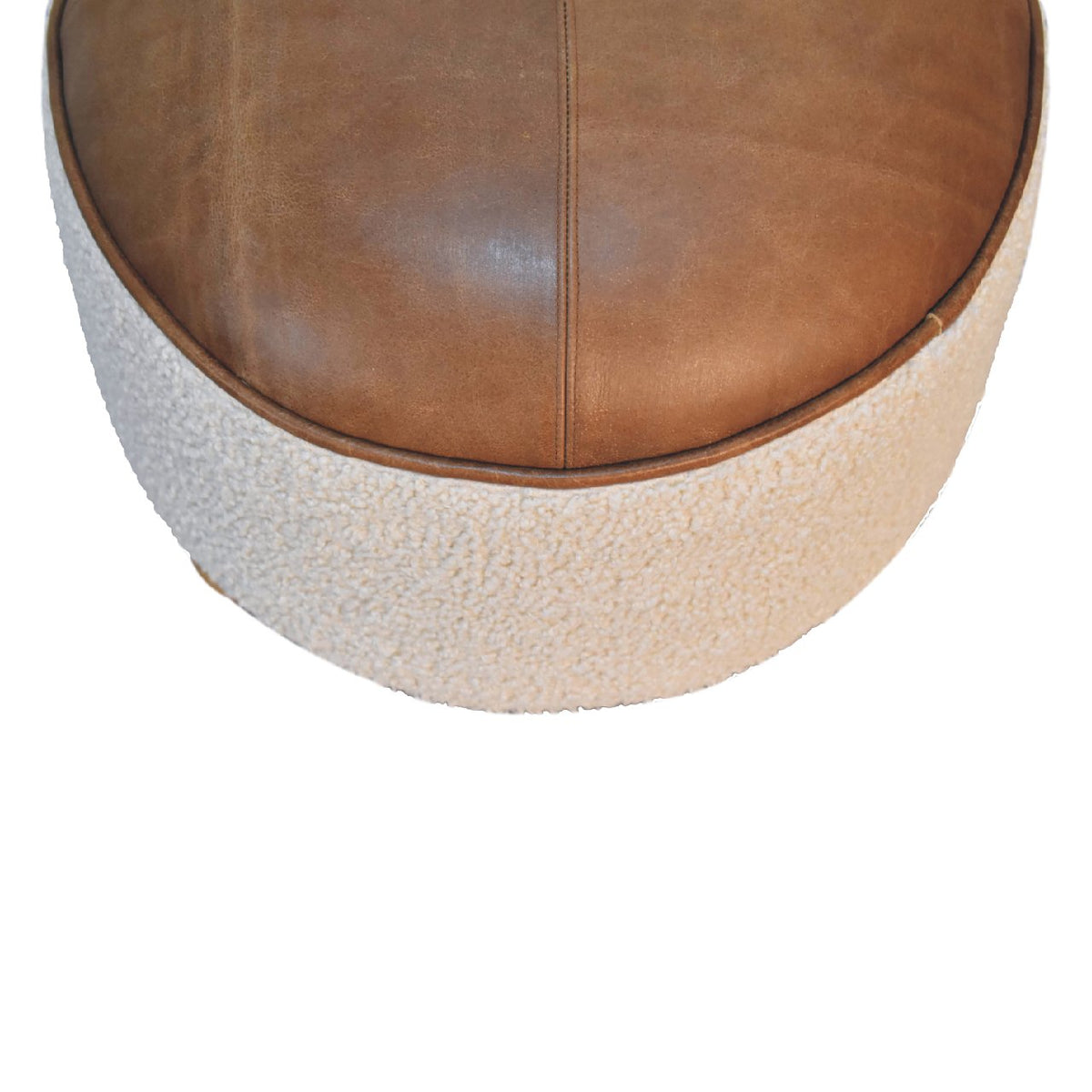 Top-down view of the brown leather seat and cream boucle footstool
