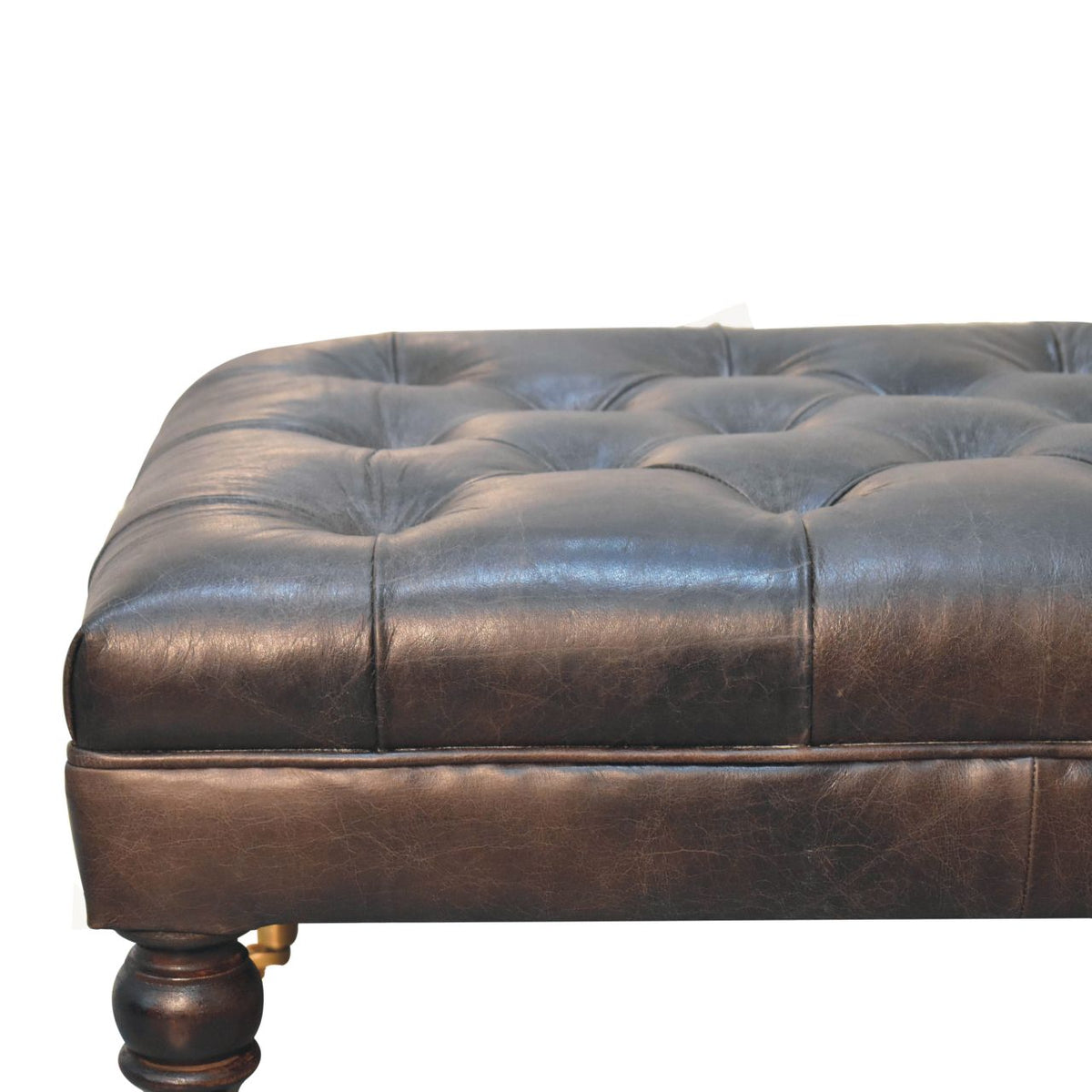 Close-up of the deep-buttoned dark leather top and turned foot