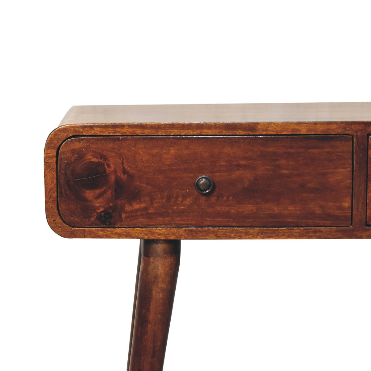 Close-up of a chestnut drawer front, dark knob and curved table edge