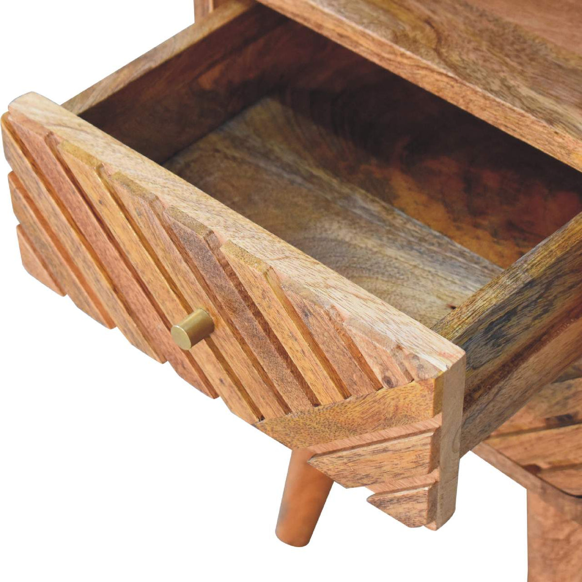 Open carved drawer showing the wood interior and round pull on the nightstand