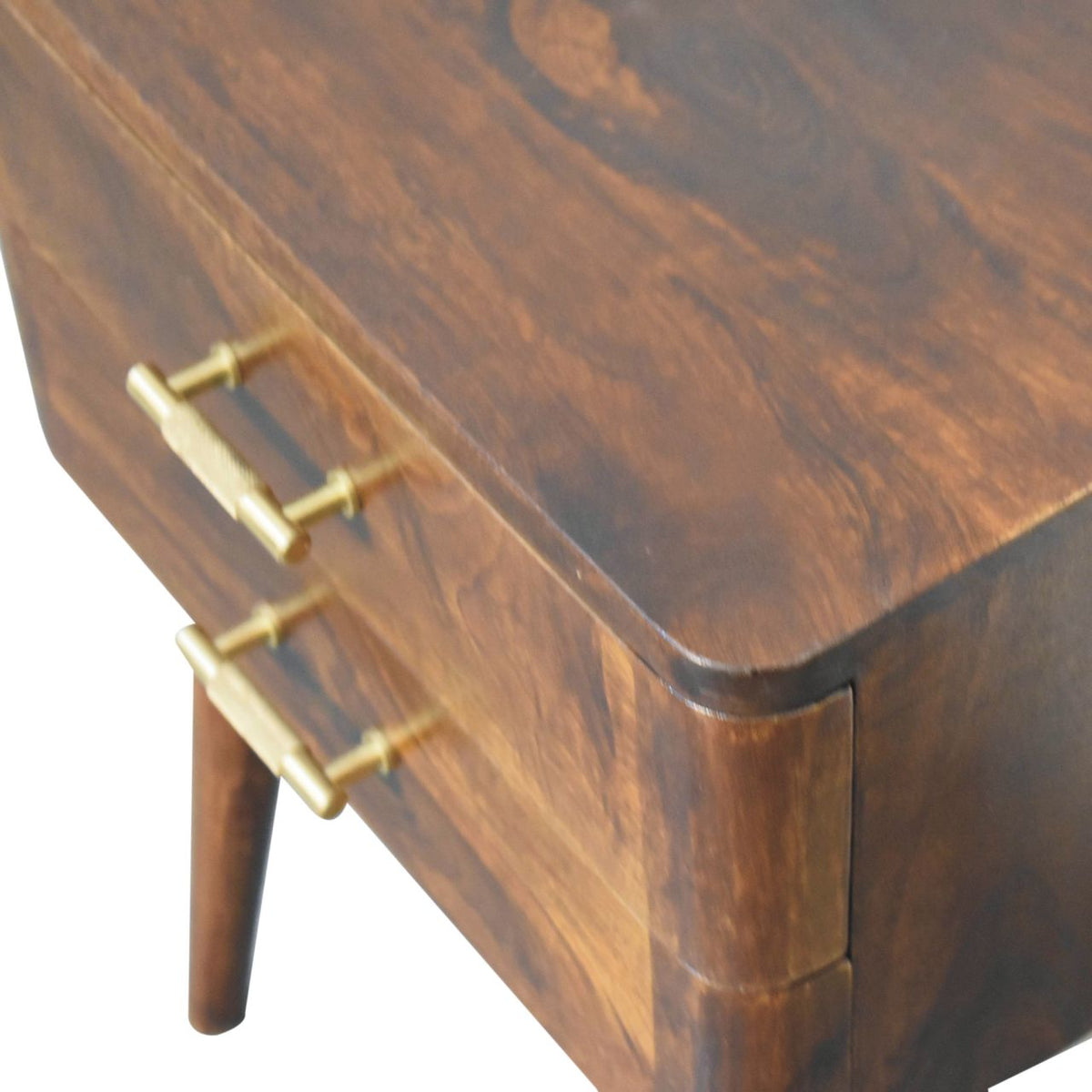Angled overhead close-up of the chestnut top and gold drawer handles