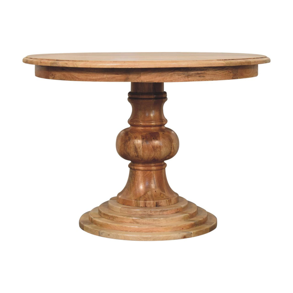 Warm brown round dining table with turned pedestal base, shown straight on against a white background