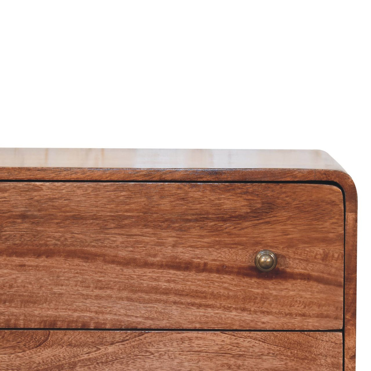 Close-up of a warm-toned wood drawer front with a round metal knob and a curved edge.