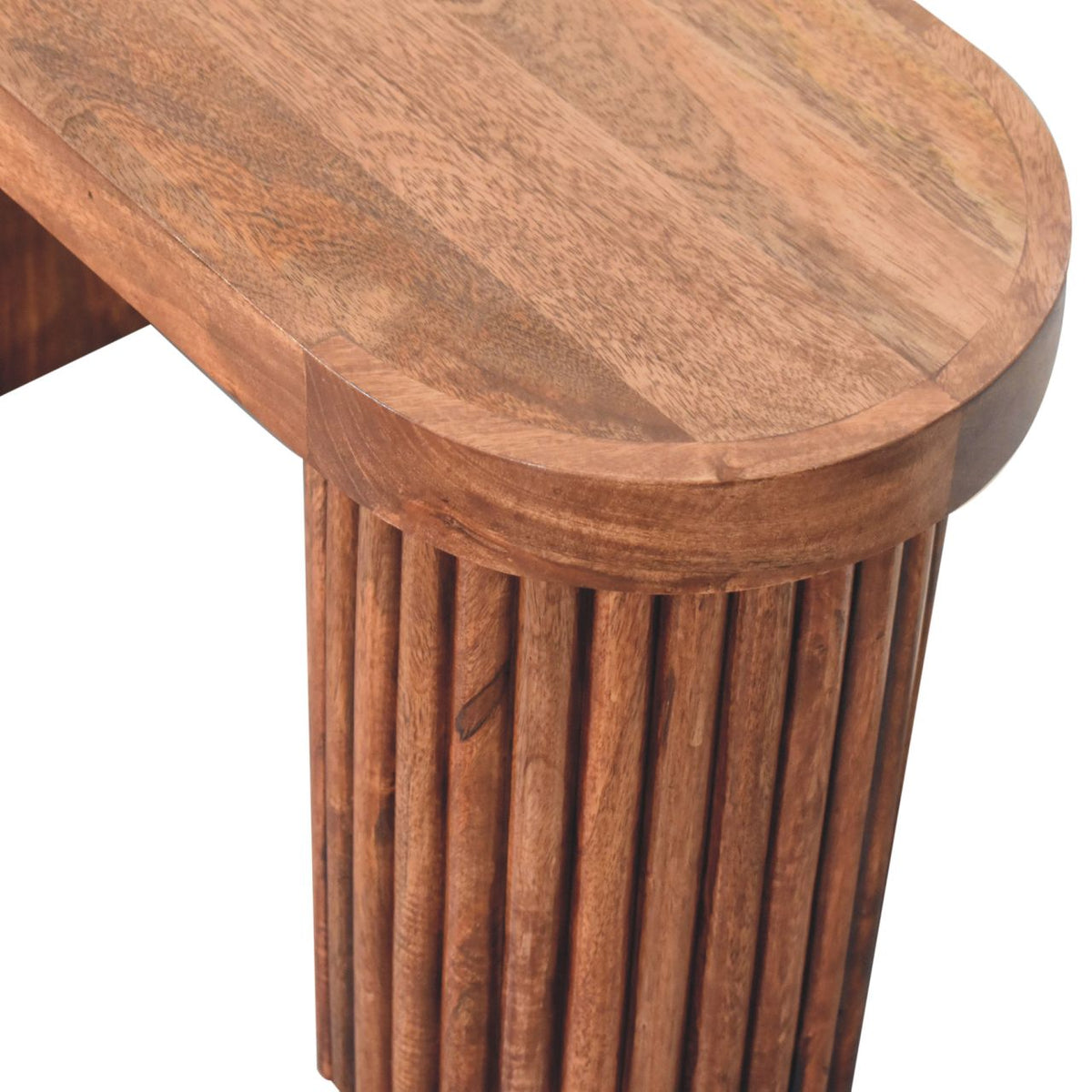 Overhead close-up of the rounded wood tabletop and fluted cylindrical table support