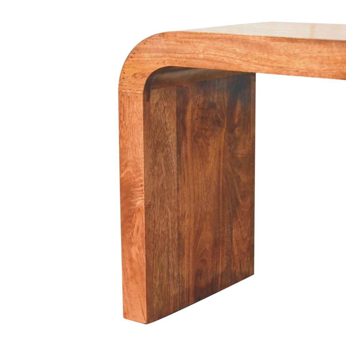 Close-up of the curved wood base and rounded edge of the honey-brown table