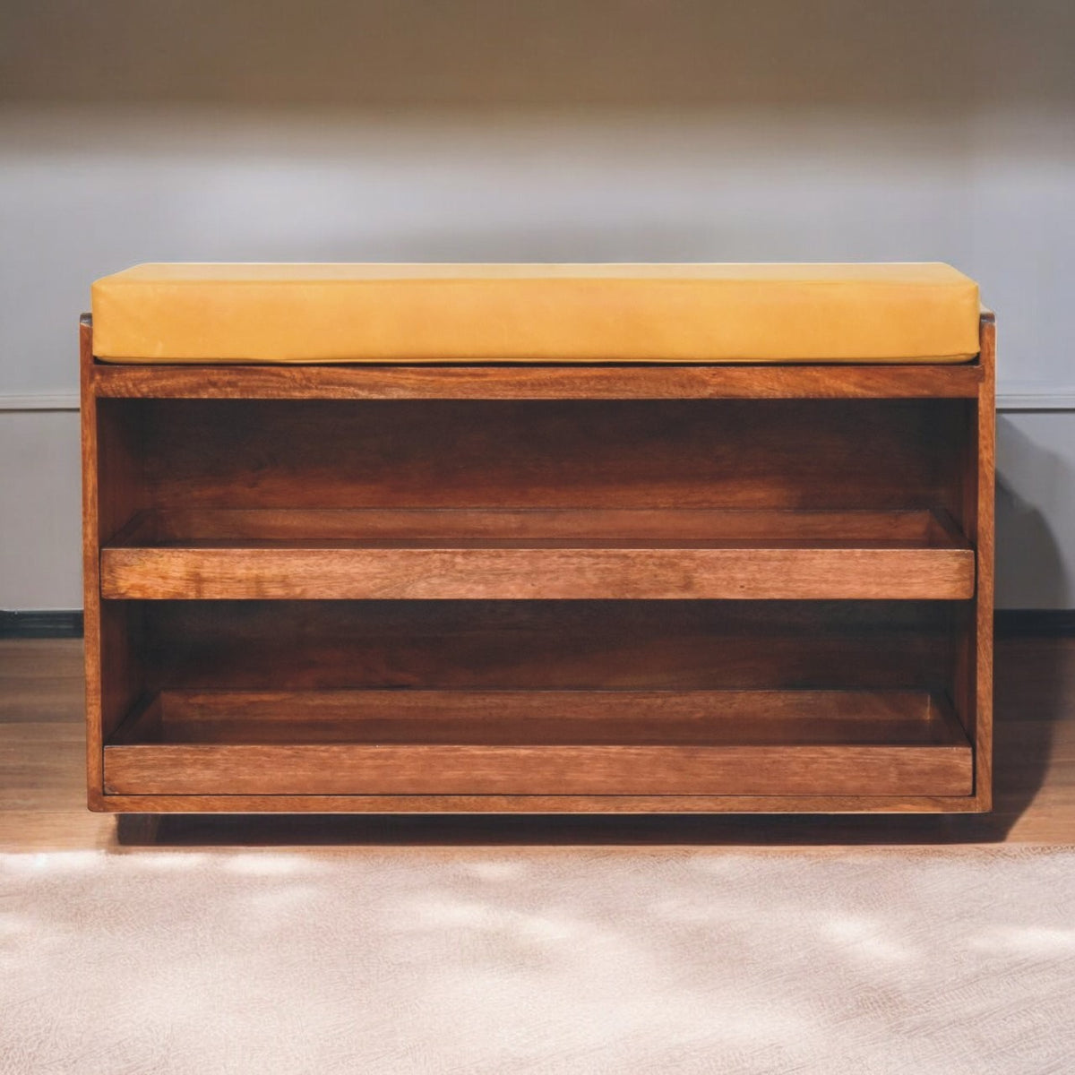 Front view of the bench showing a tan seat cushion and two open wooden shelves.