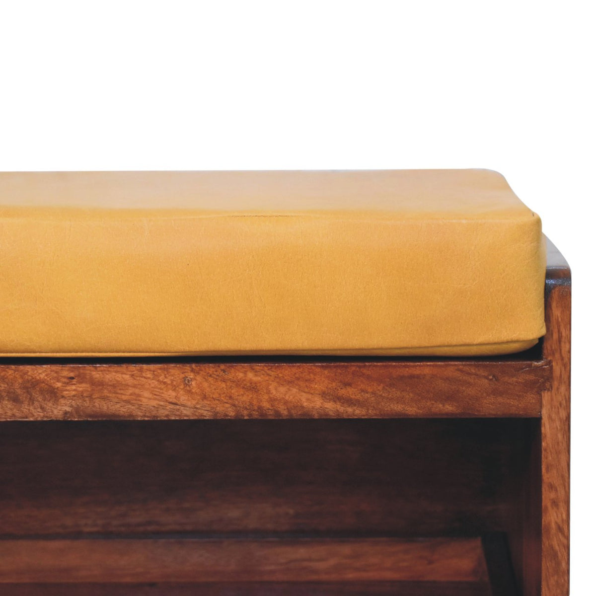 Close view of the tan cushion and brown wood frame on the shoe bench