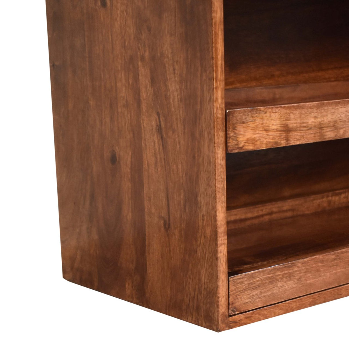 The bench’s broad wooden side panel beside the edges of its open shelves.