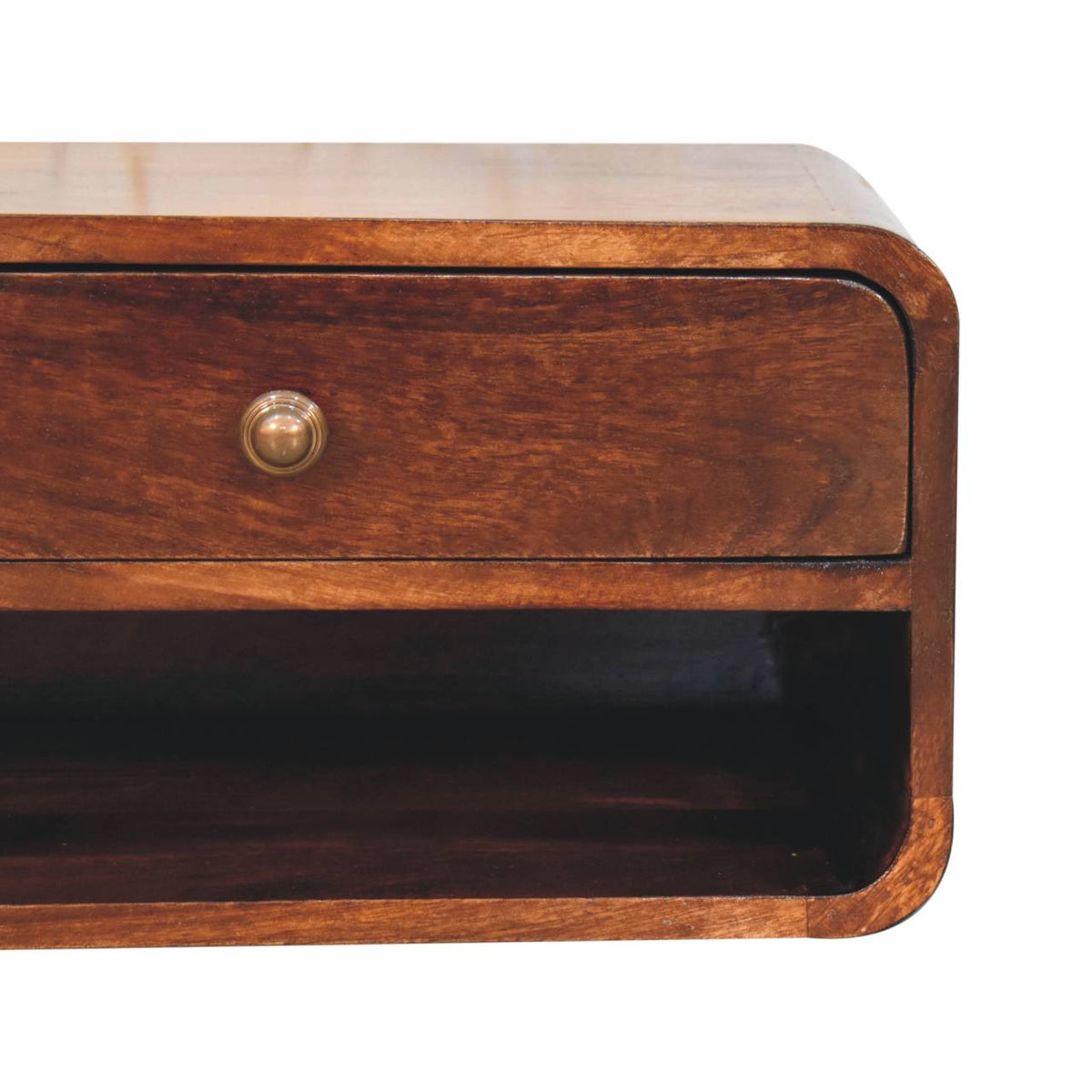 Close-up of a curved walnut-finish nightstand front, showing a small round drawer knob and open shelf.