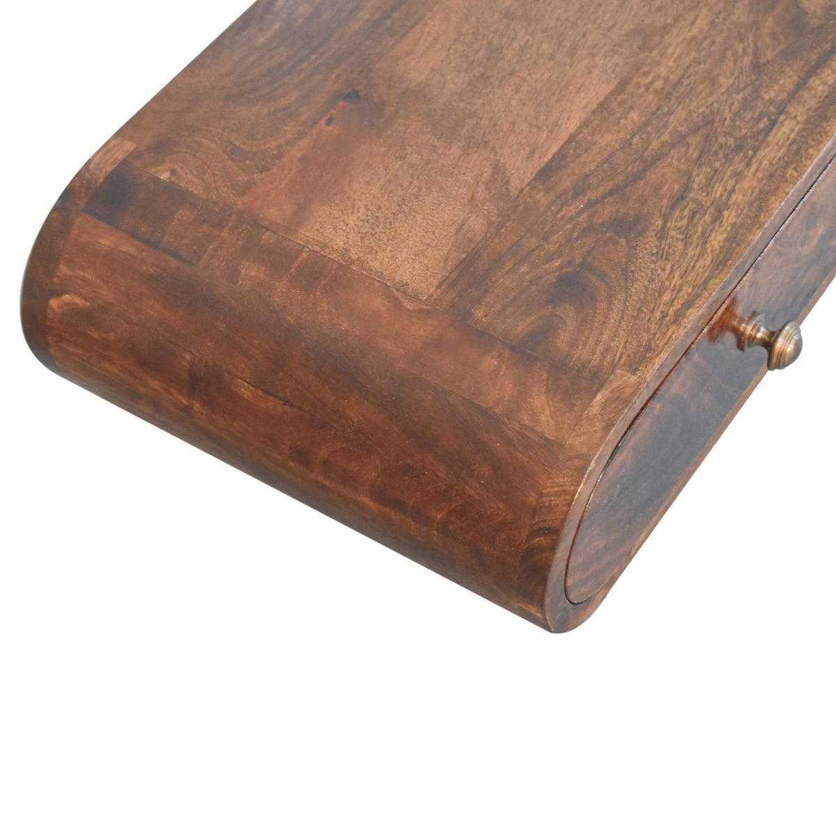 Close-up of the console table's curved brown wood top and rounded edge