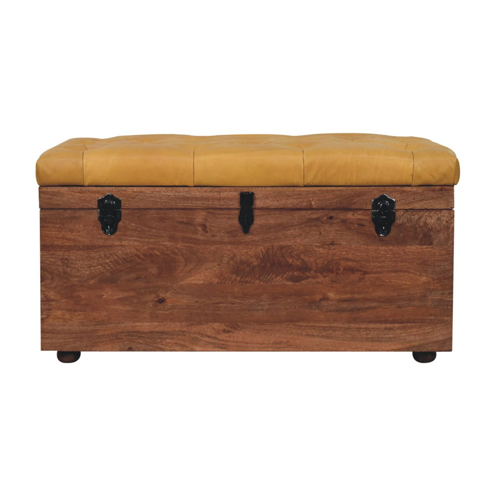 Honey caramel upholstered storage trunk in a straight-on front view on white.