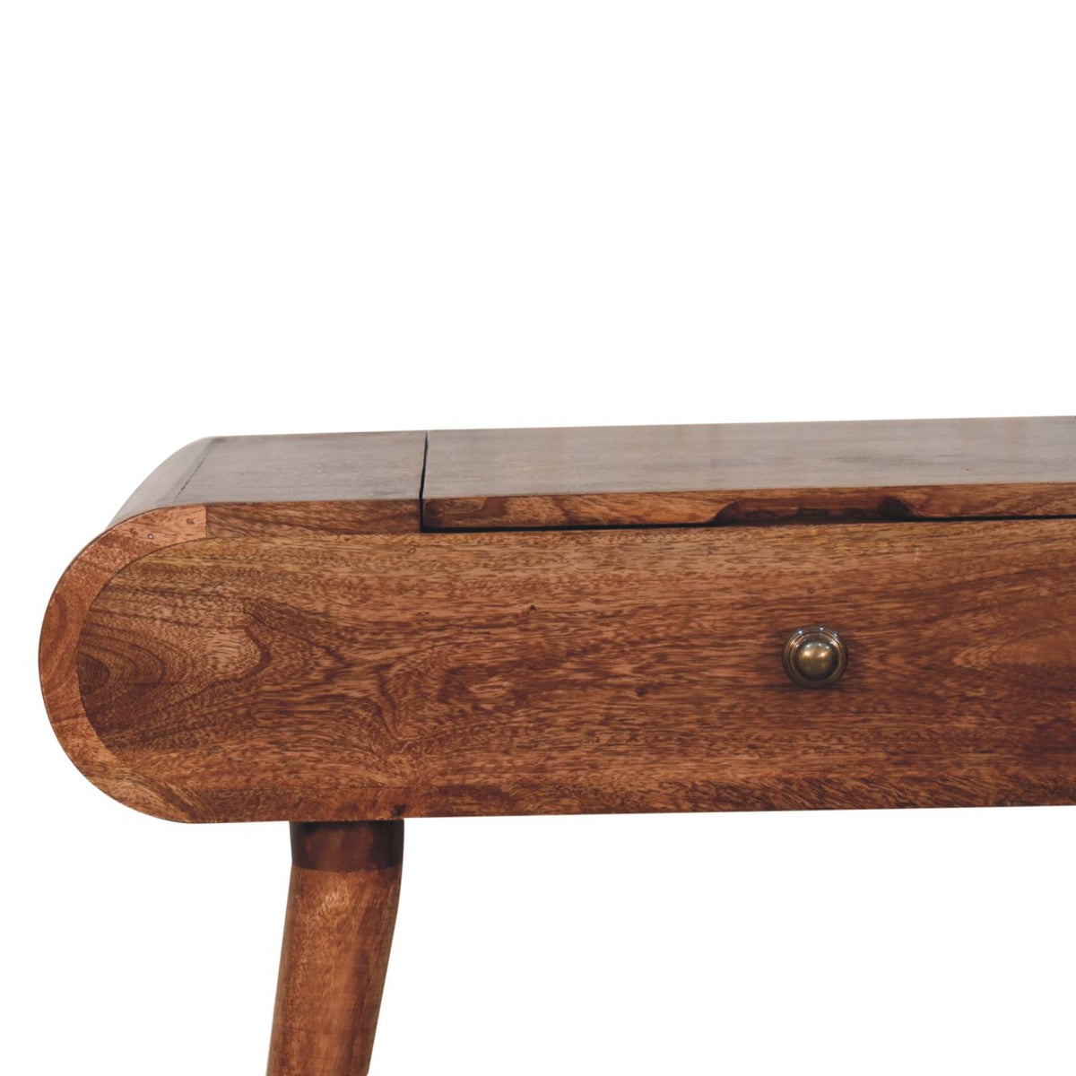 Close-up of the dressing table's rounded wooden drawer front and tabletop