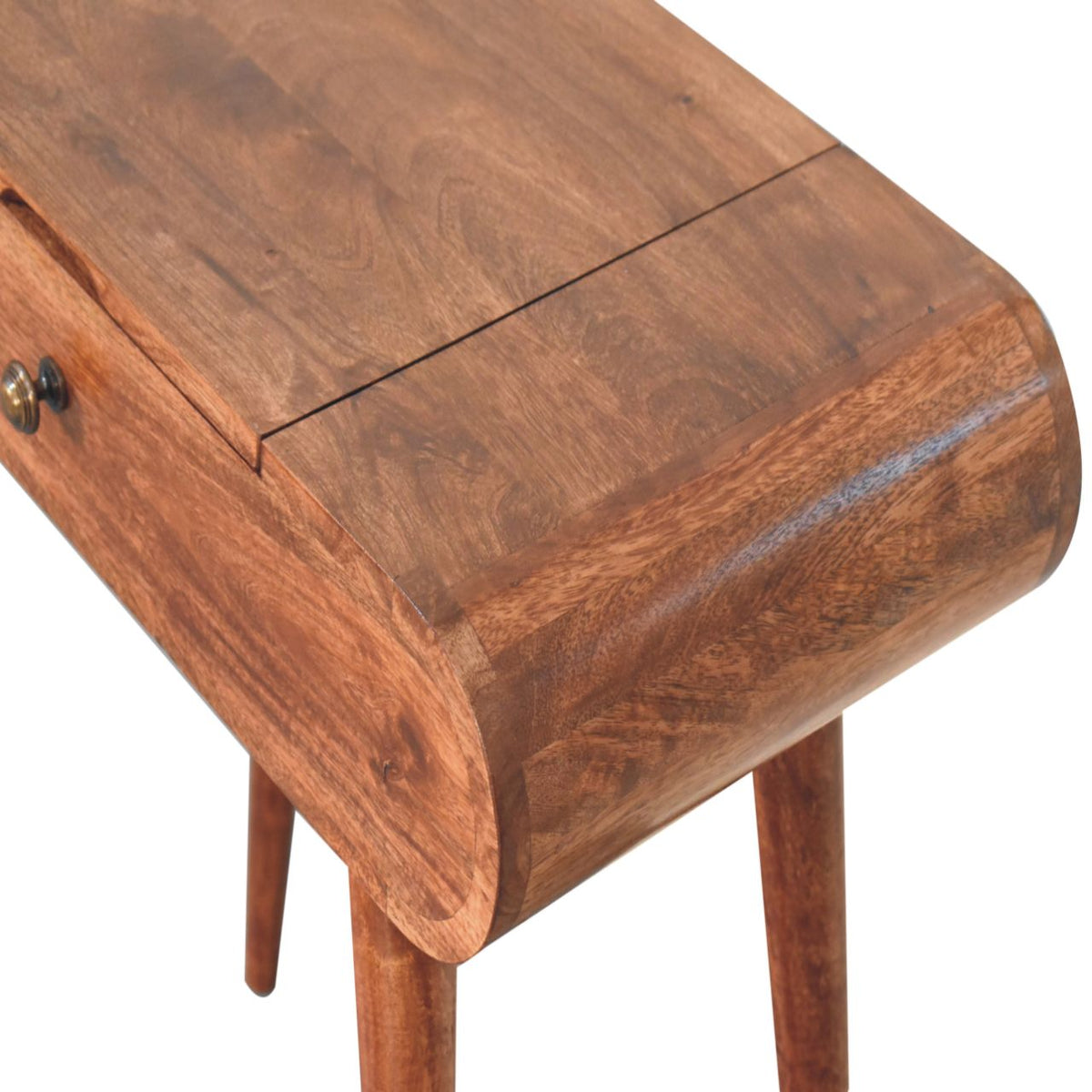 Close-up of the dressing table's honey-brown wood grain and rounded tabletop corner