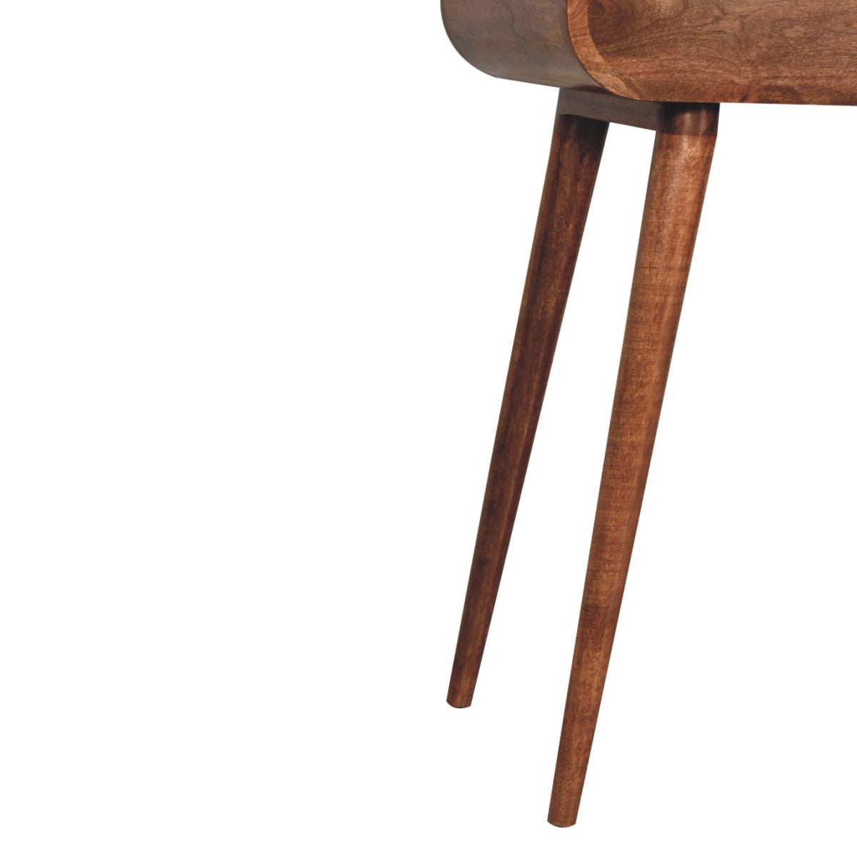 Close-up of two tapered wooden legs beneath the rounded edge of a dressing table.