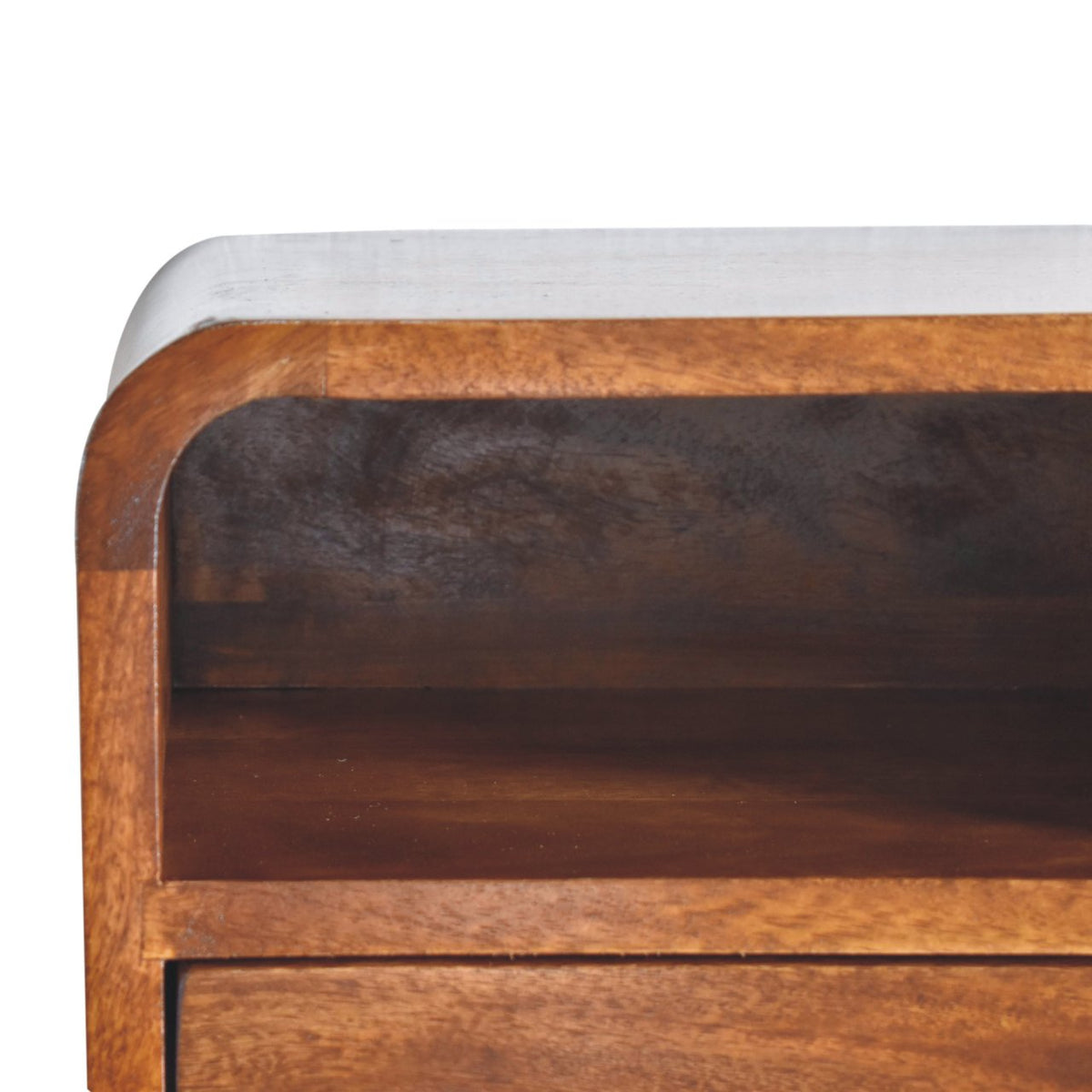 Close-up of the bedside’s curved wooden frame and empty open slot above the drawer.