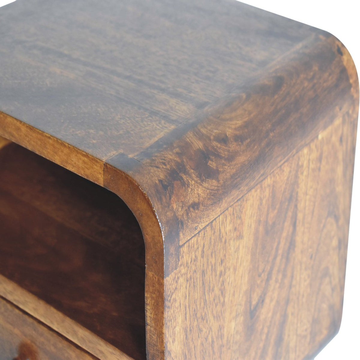 Close view of the wood grain across the top and rounded side edge, with the open slot partly visible.