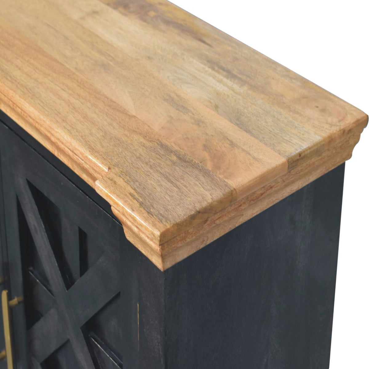 Angled detail of the natural-toned top meeting the ash black side of the sideboard