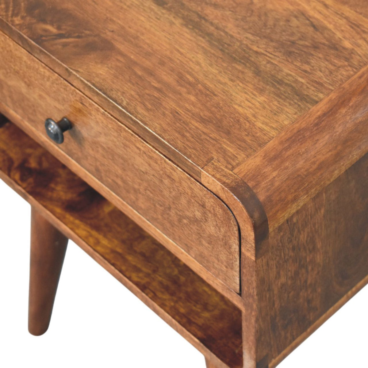 Close-up of the rounded wooden top edge, dark drawer knob, and open slot beneath the drawer.
