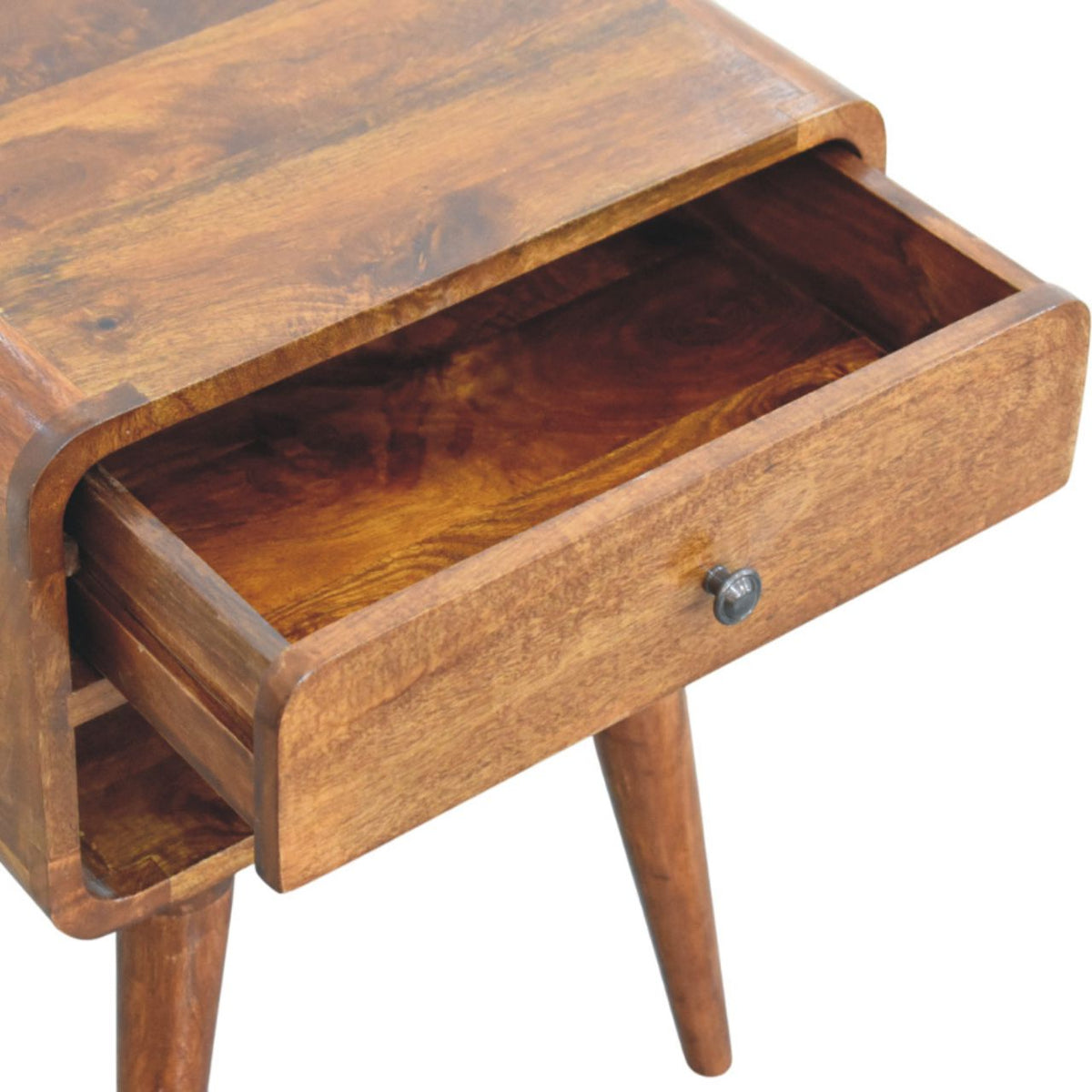 The nightstand’s drawer is pulled open, showing its empty wooden interior and round dark knob.