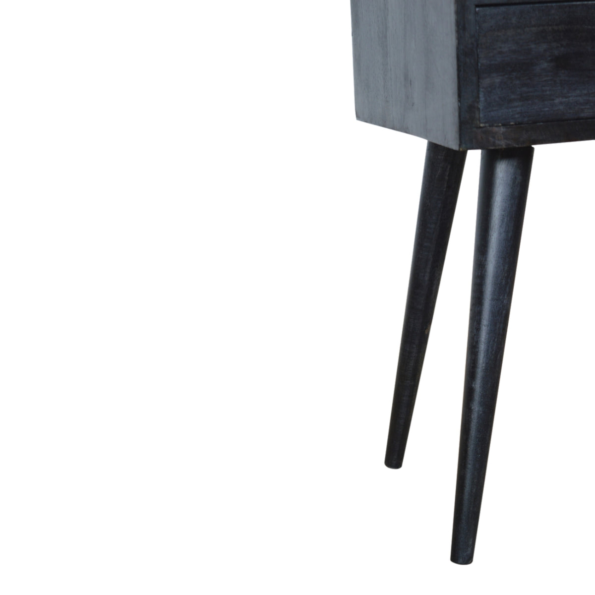 Detail of the ash black nightstand's side panel and long legs
