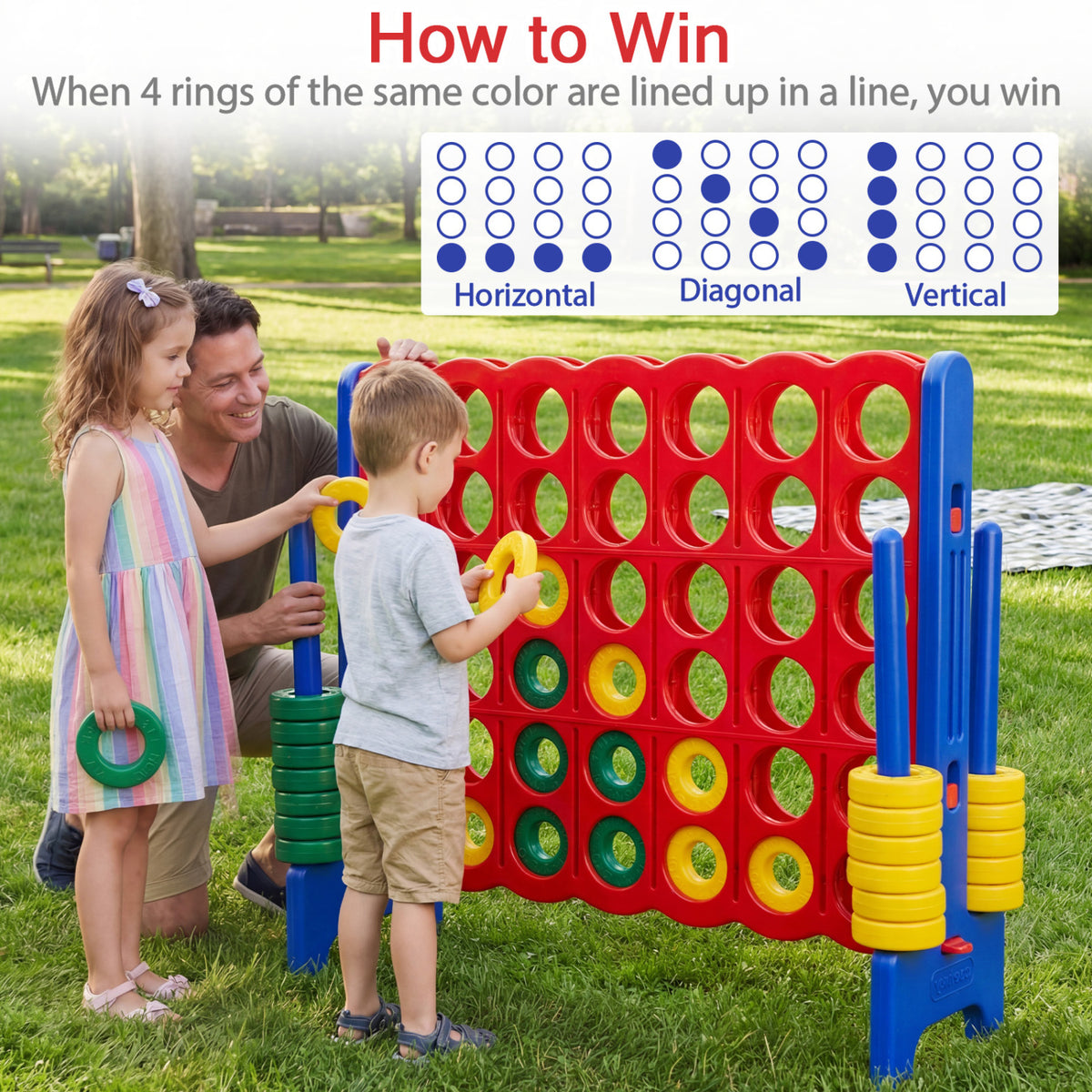 Two children and an adult play the red-and-blue ring game outdoors on grass.