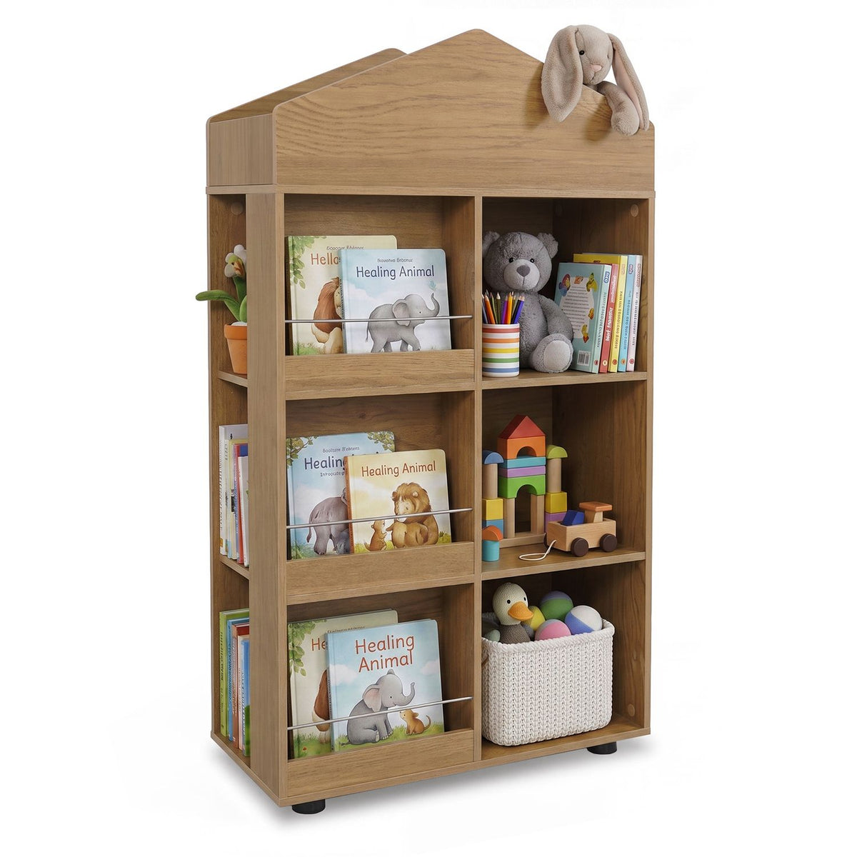 House-shaped wooden bookshelf displaying books, a plush rabbit, toys and a woven storage basket.